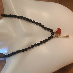 Black beaded vintage fossil necklace with key.